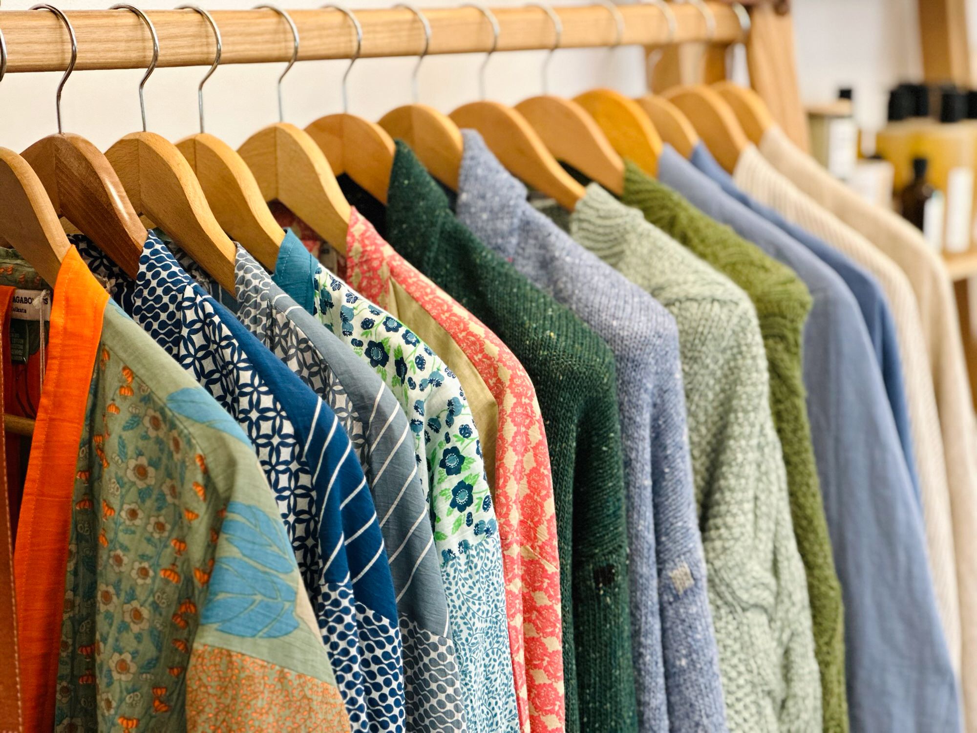 Colourful clothing on wooden hangers